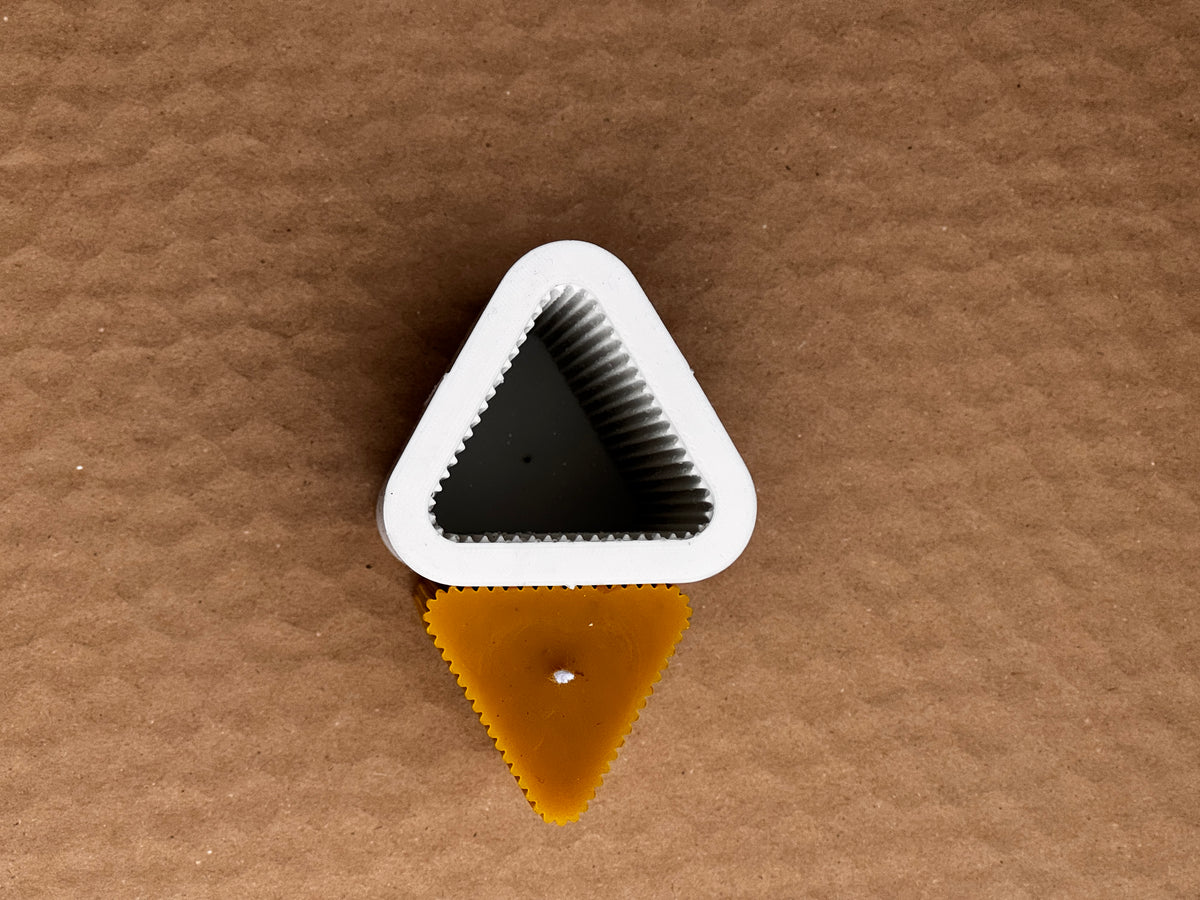 Top-down view of the Triangle Fluted Pillar silicone mould opening above the triangular candle top