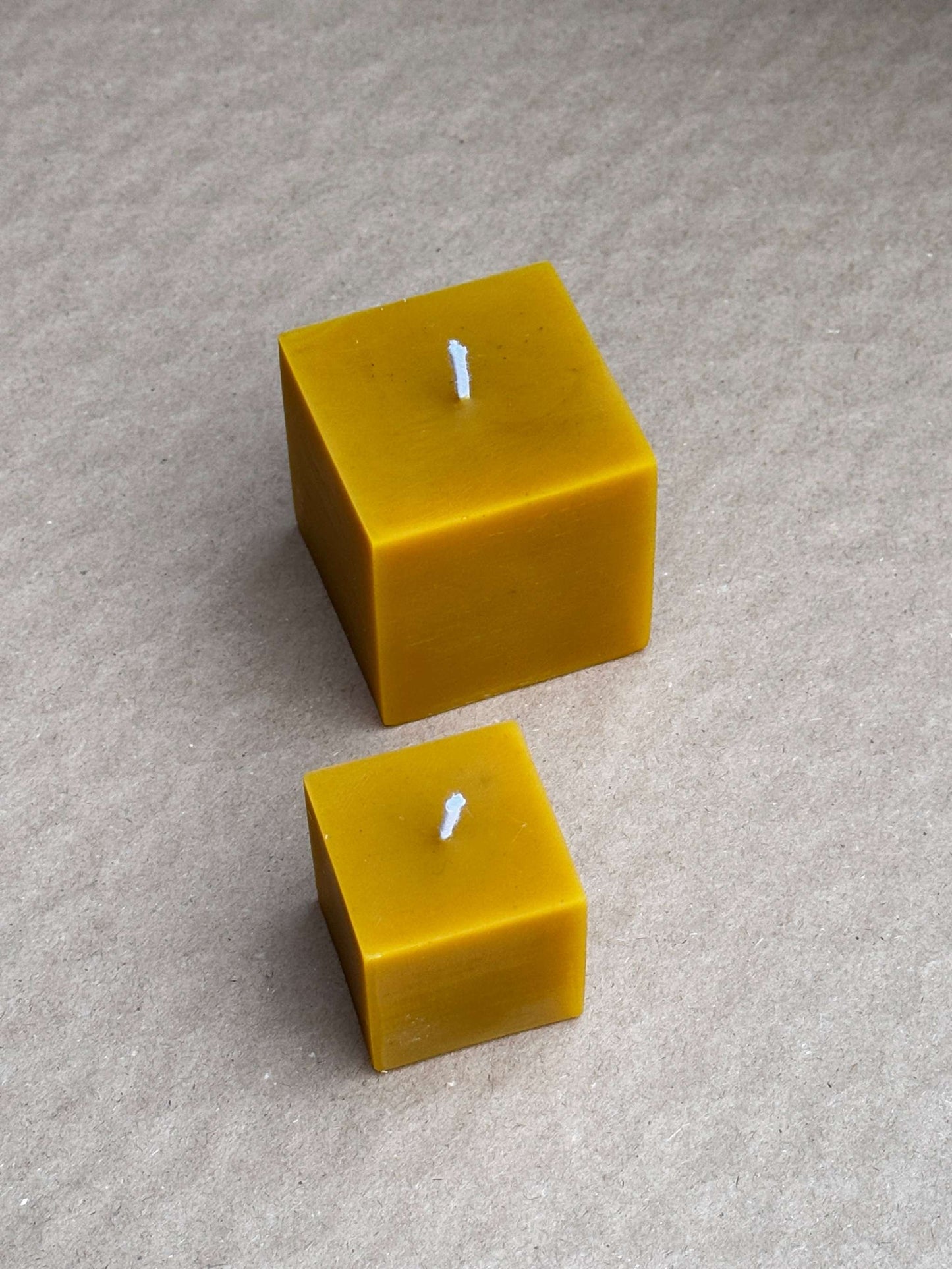 Small and medium silicone candle molds shaped like cute cubes.