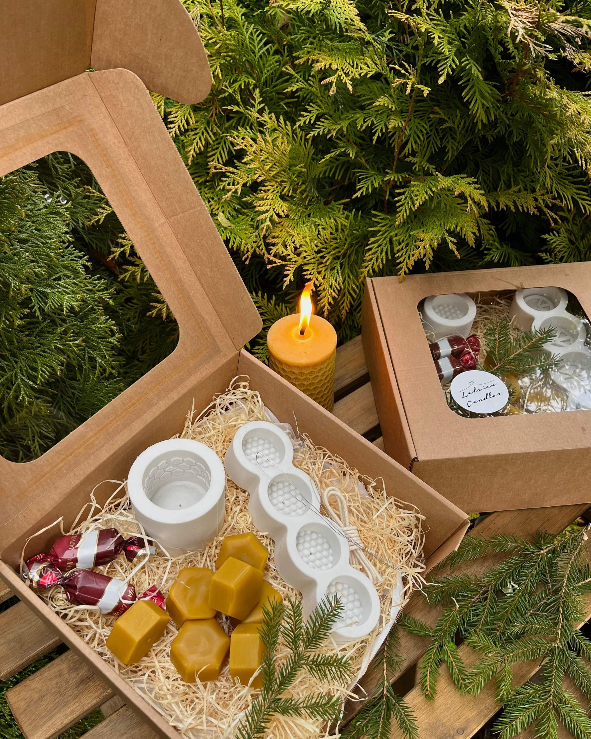 Christmas gift box with candle making kit, silicone molds, wax, wicks, and sweets, perfect holiday surprise.