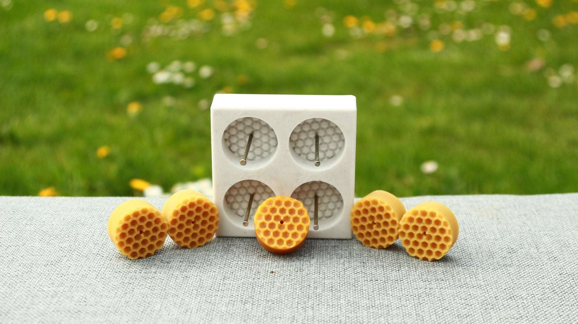 BEE CELLS TEA LIGHTS silicone candle mold with four cavities and hexagonal pattern design.