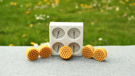 BEE CELLS TEA LIGHTS silicone candle mold with four cavities and hexagonal pattern design.