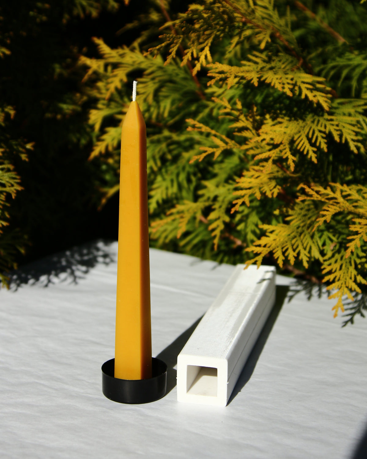 Side view of the obelisk-shaped beeswax candle