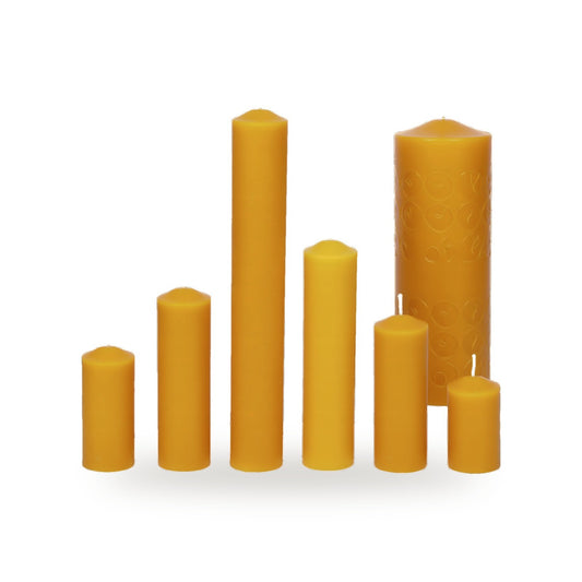 Six Simplicity beeswax pillar candles in different sizes on a white background