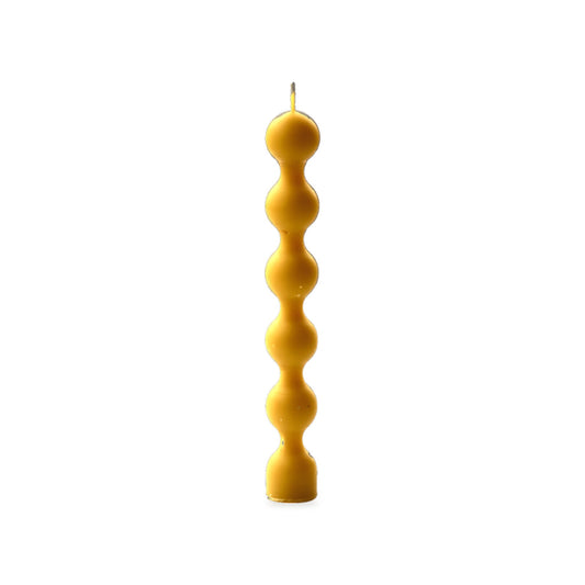 Beads beeswax candle, white background studio photo