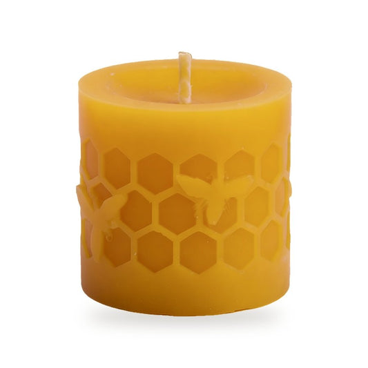Bees On Cells beeswax candle, white background studio photo