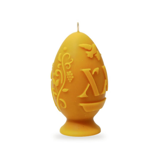 Egg With Motives beeswax candle, white background studio photo