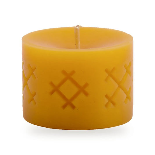 Ethno Cross beeswax candle, white background studio photo
