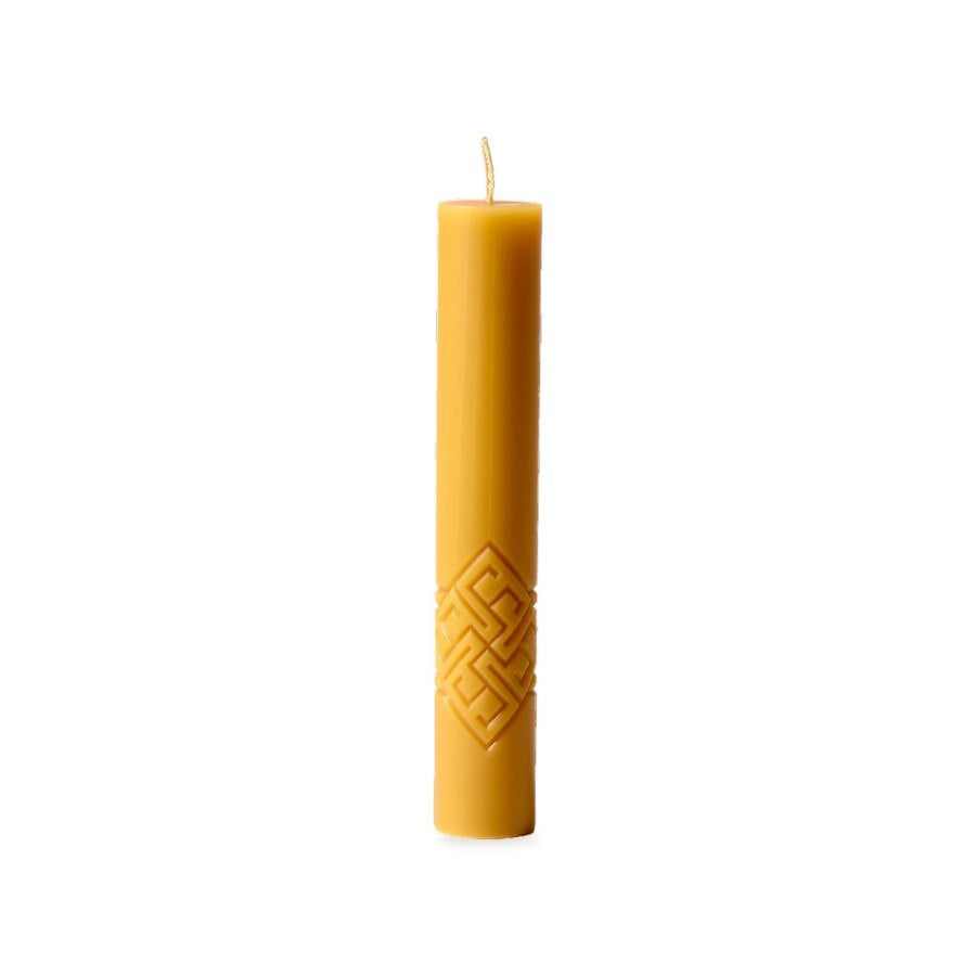 Geometric folk signs beeswax pillar with geometric motif on a white background