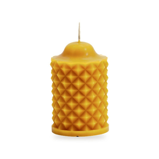 Scalloped Cylinder beeswax candle, white background studio photo