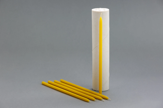 Silicone candle mold with long tiny taper candles.