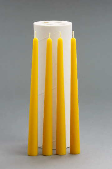 Silicone candle mold with four yellow taper candles, 24 cm high and 2.2 cm wide.