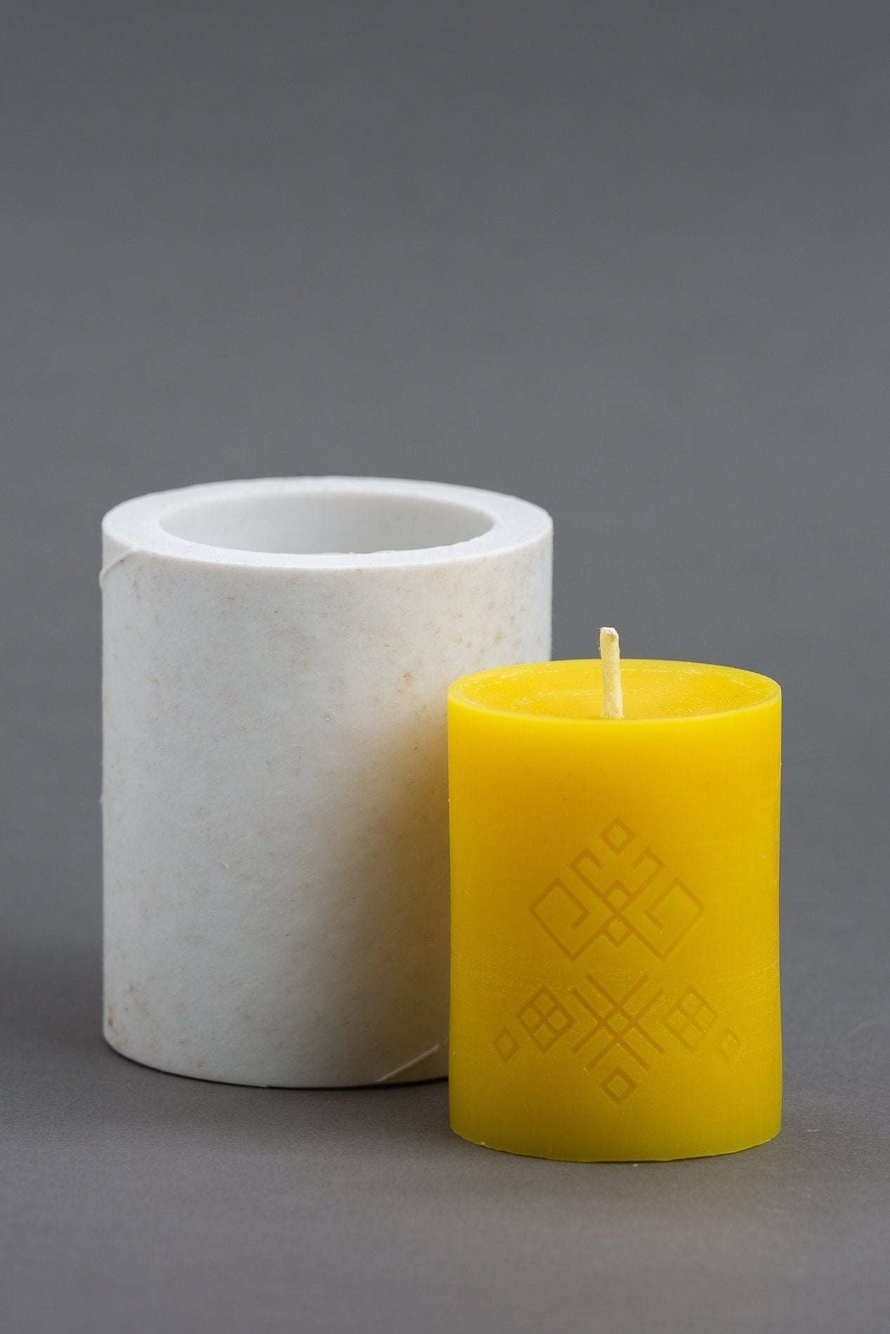 KARELIA MOTIVES 2 Sizes Silicone Candle Molds with yellow candle showing ornament detail.