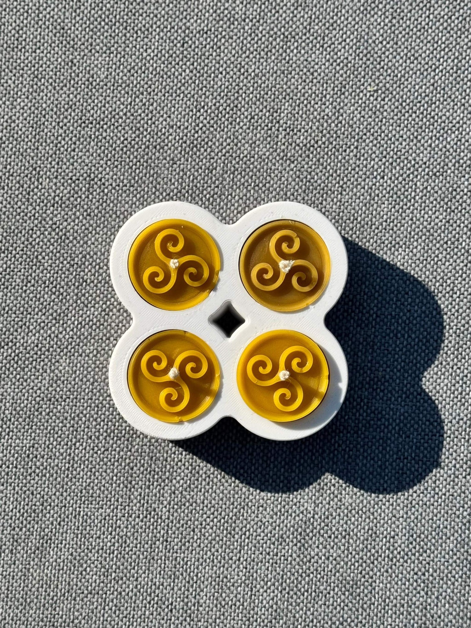 Beeswax tea light candle with wave-inspired rose pattern