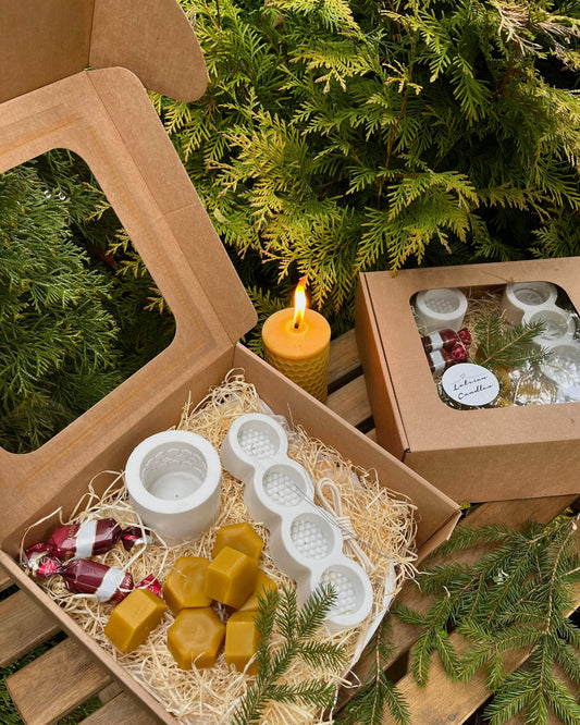 Christmas gift box with candle making kit, silicone molds, wax, wicks, and sweets, perfect holiday surprise.