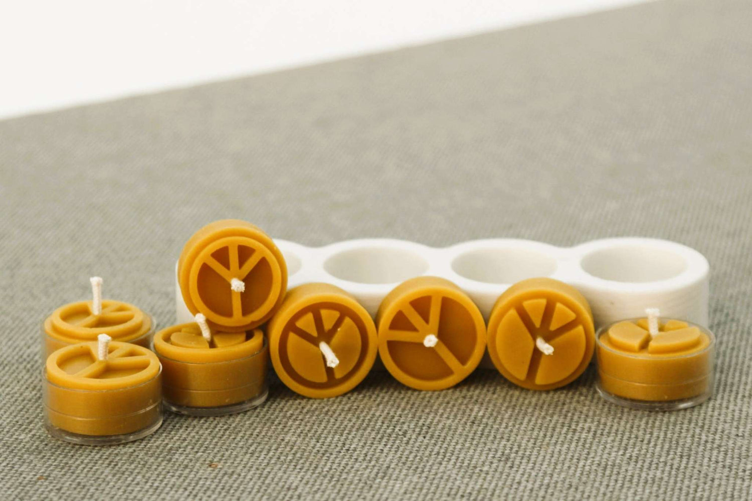 Beeswax tea light candle with peace symbol