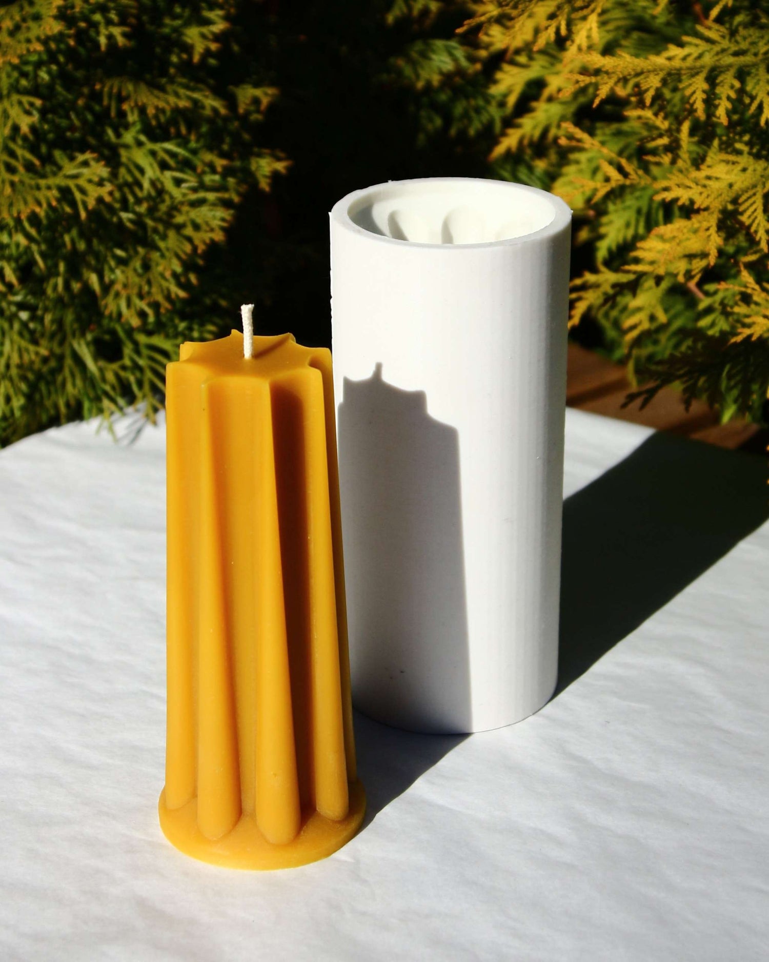 Beeswax cylinder candle with blended geometric surface