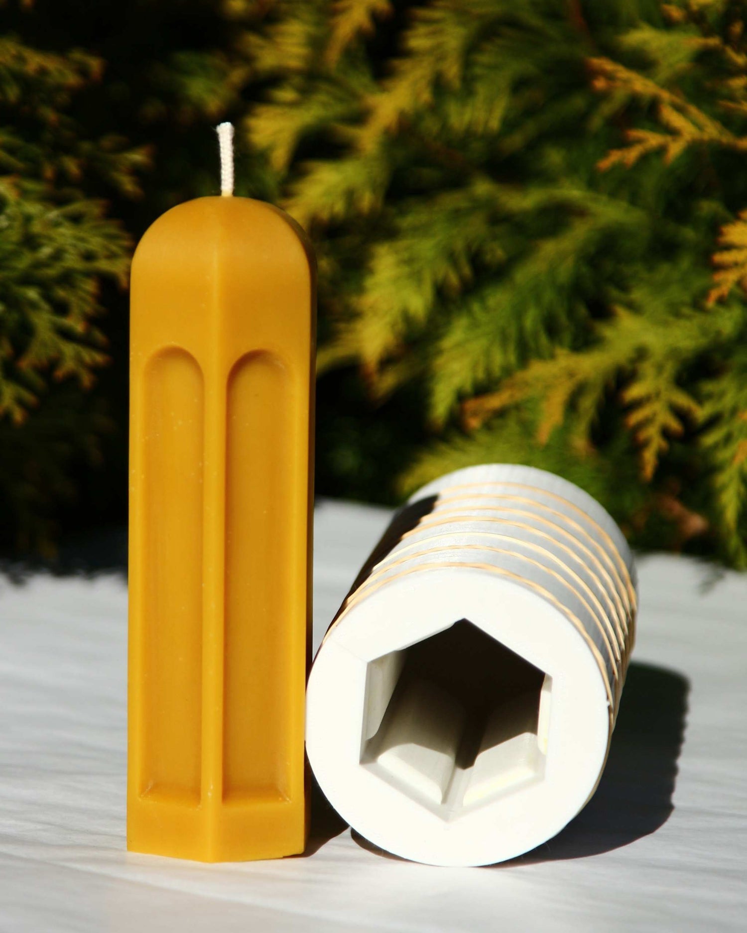 Beeswax candle with pavilion-inspired geometric form