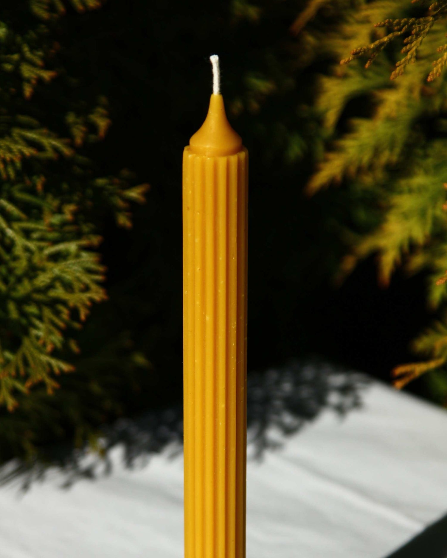 Beeswax taper candle with pointed fluted design
