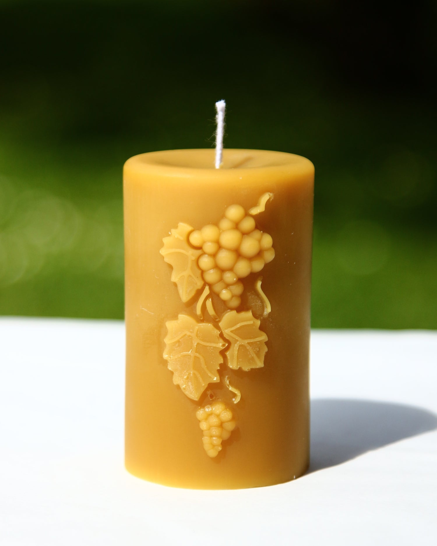 Beeswax candle shaped like a cluster of grapes