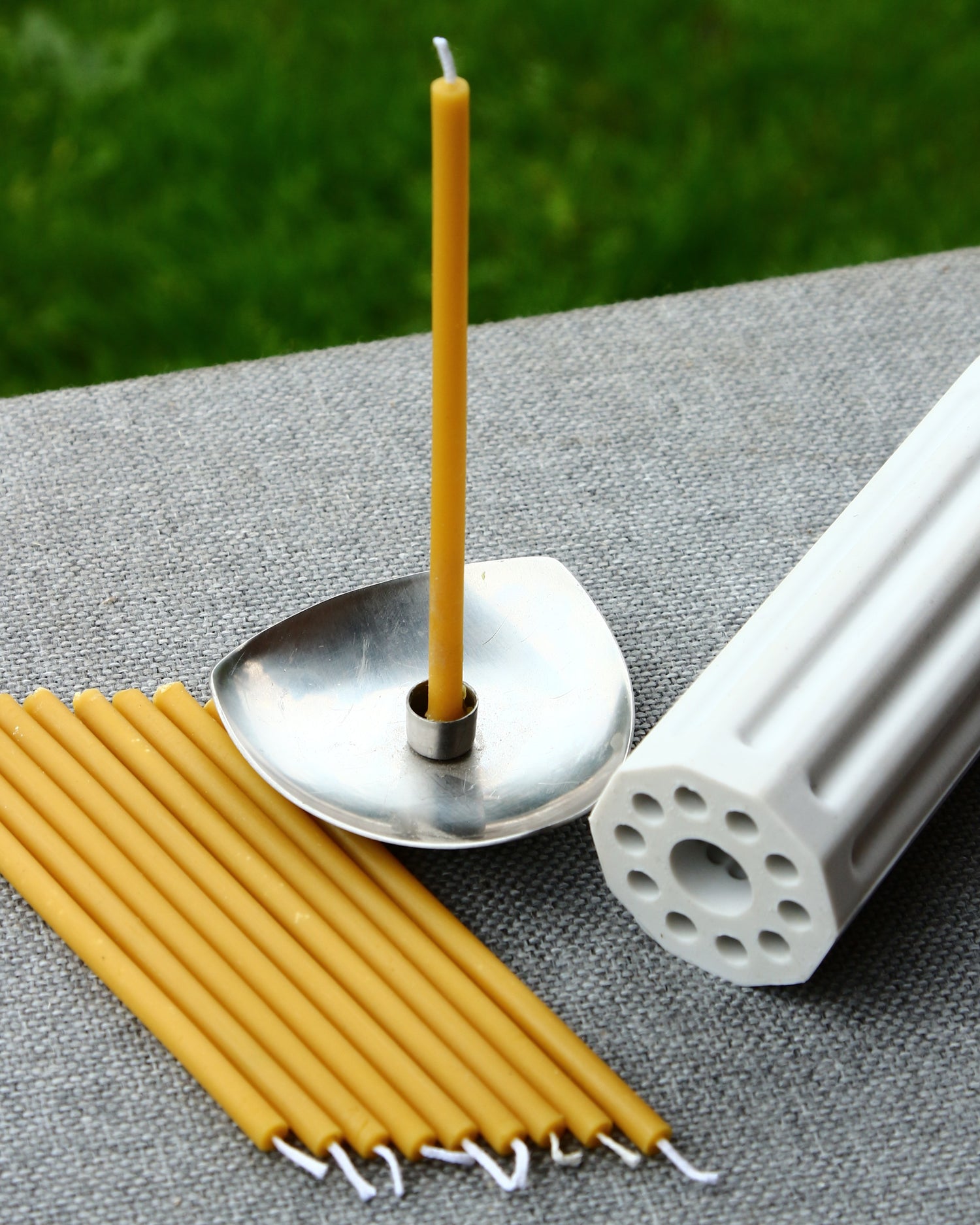 Finished beeswax candle with architectural stepped form