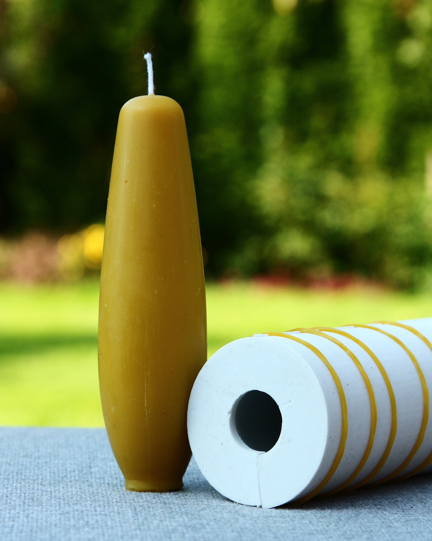 Finished beeswax taper candle with smooth spindle shape
