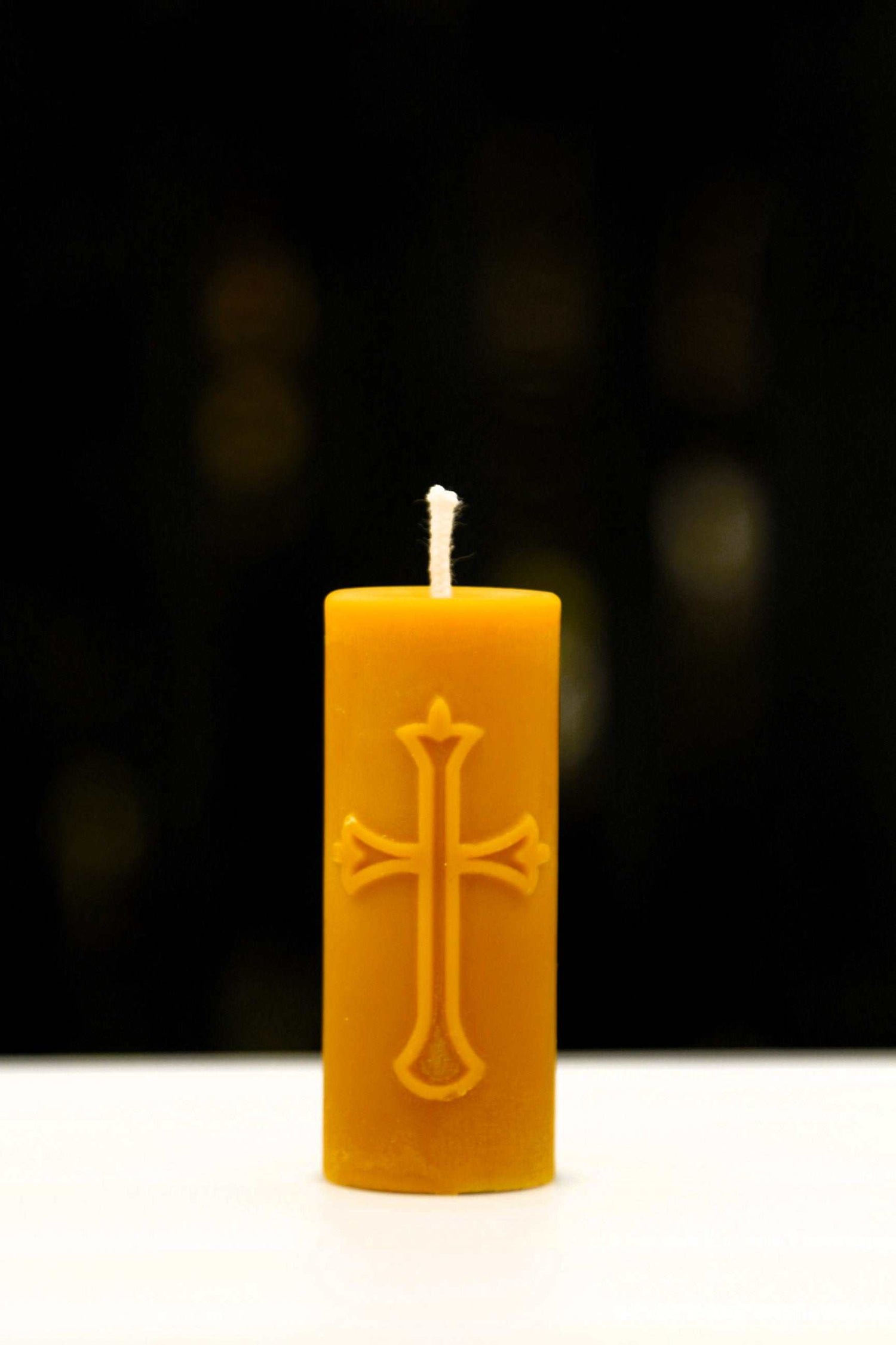 Set of beeswax candles with religious symbols