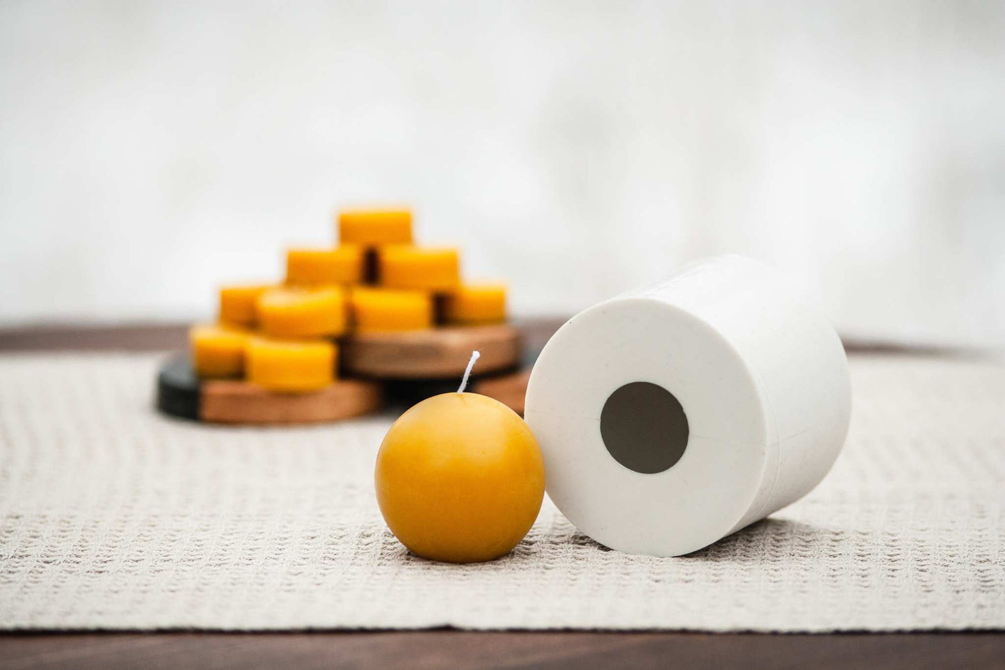 Side view of ball-shaped beeswax candle