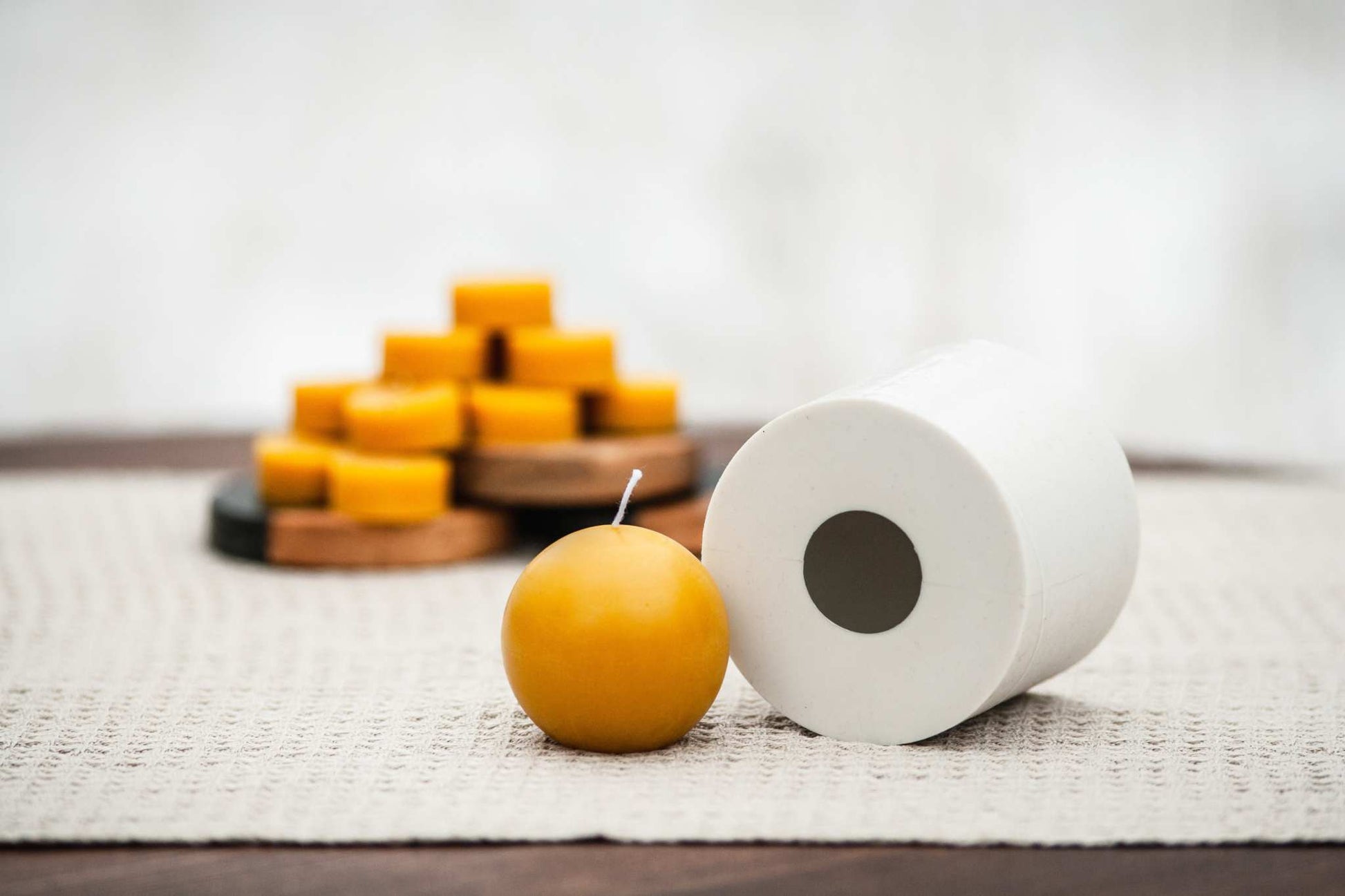 Side view of ball-shaped beeswax candle