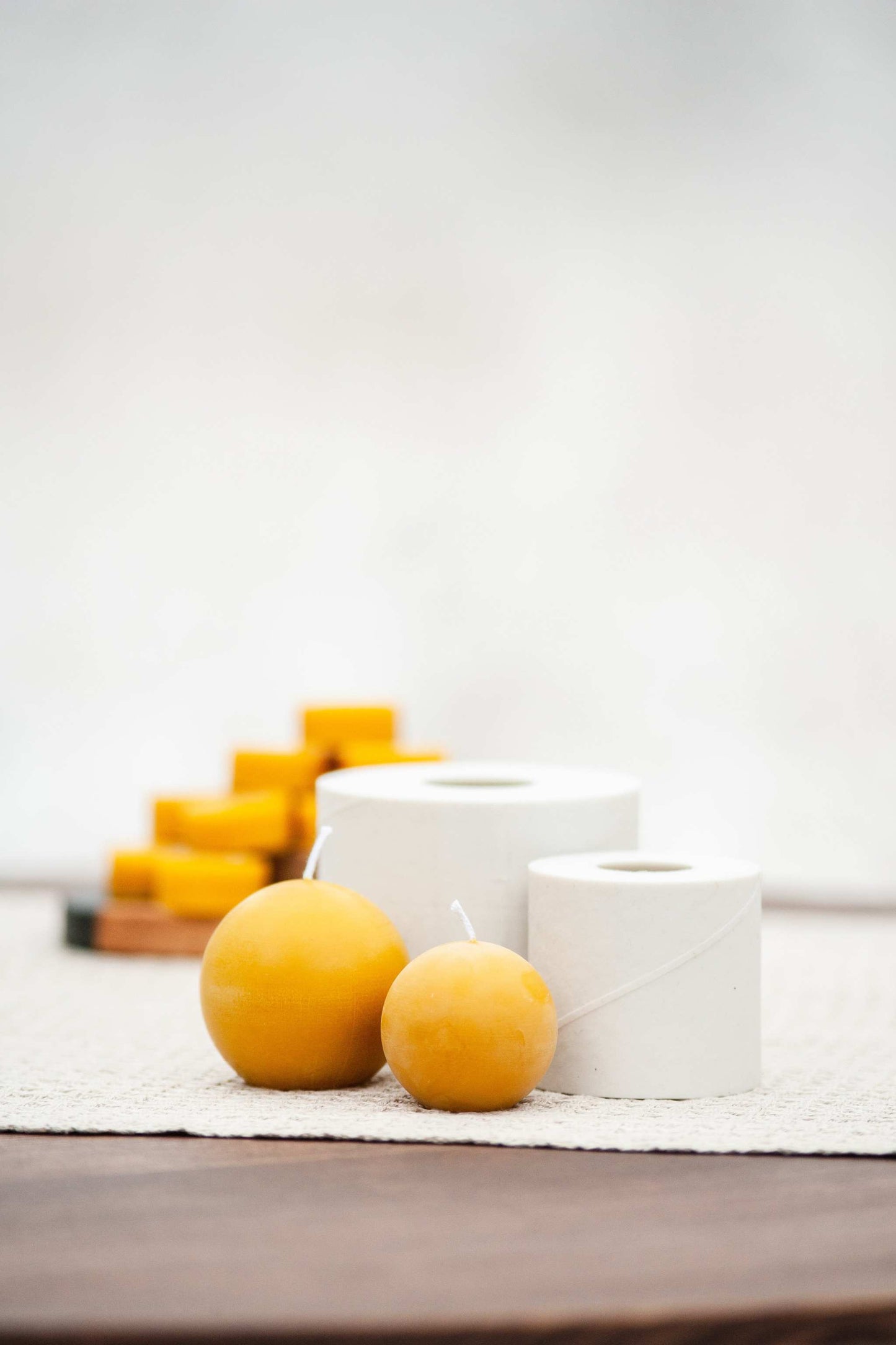 Minimalist round beeswax candle and silicone mold in natural setting