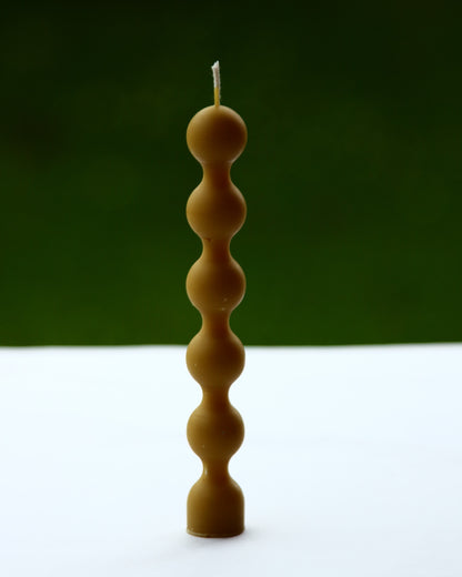 Side view of beaded beeswax candle