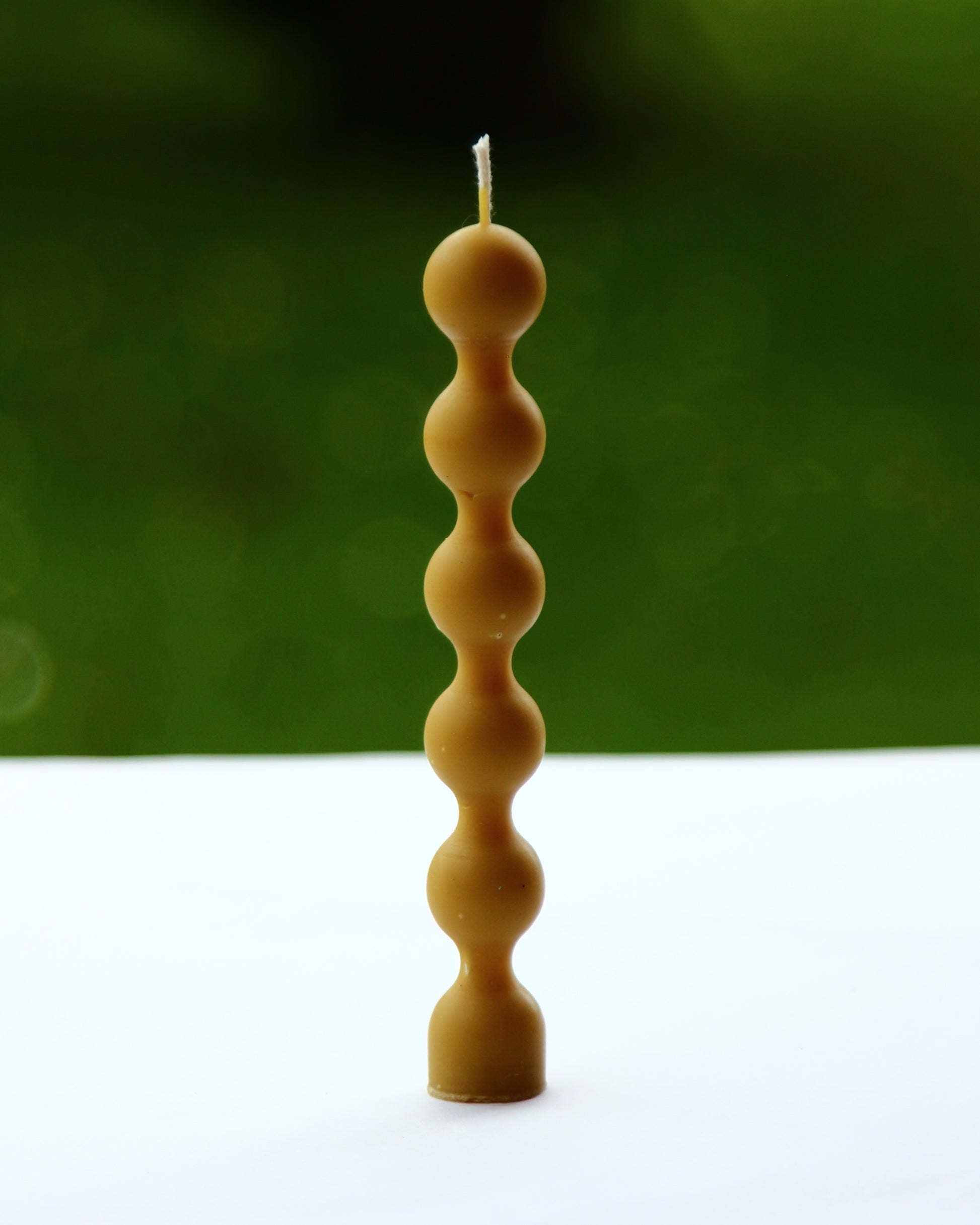 Close-up of bead texture on beeswax candle