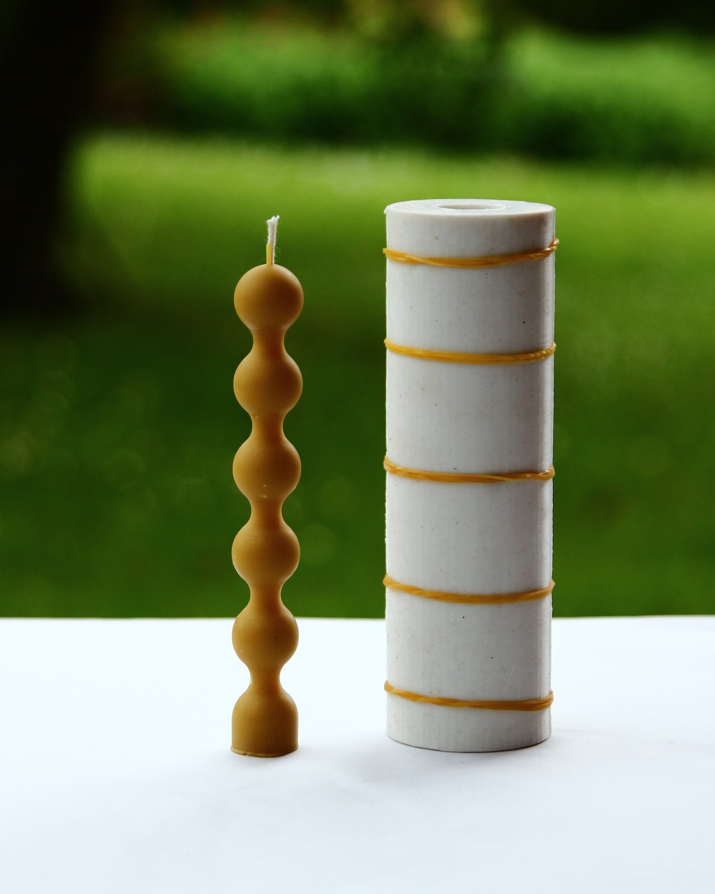 Beeswax candle with rounded bead-like segments