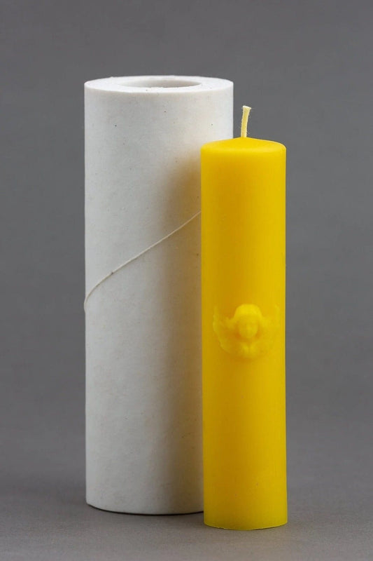Yellow candle next to a white cylindrical container on a gray background