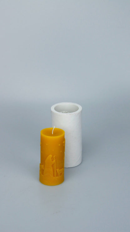 Christmas Scene beeswax candle with relief detail beside the silicone mould