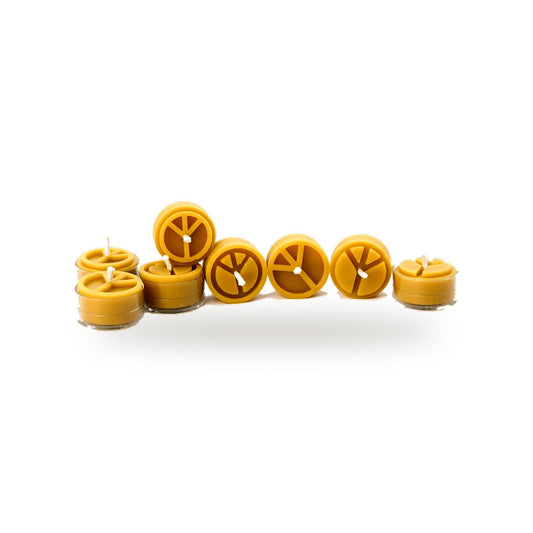 Group of Peace tea lights with peace symbol tops on a white background