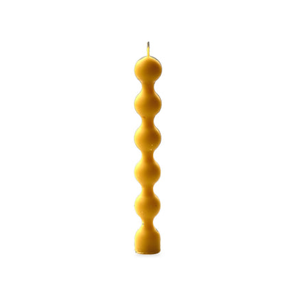 Beads beeswax candle, white background studio photo