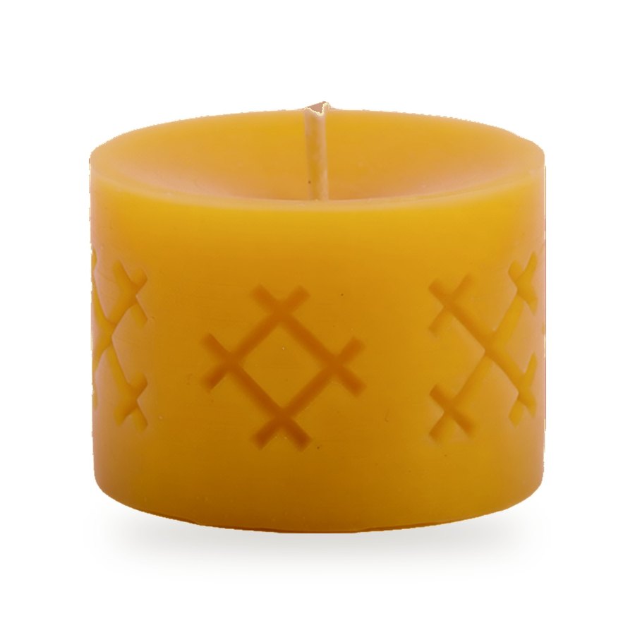 Ethno Cross beeswax candle, white background studio photo