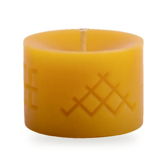 Ethno Jumis beeswax candle, white background studio photo