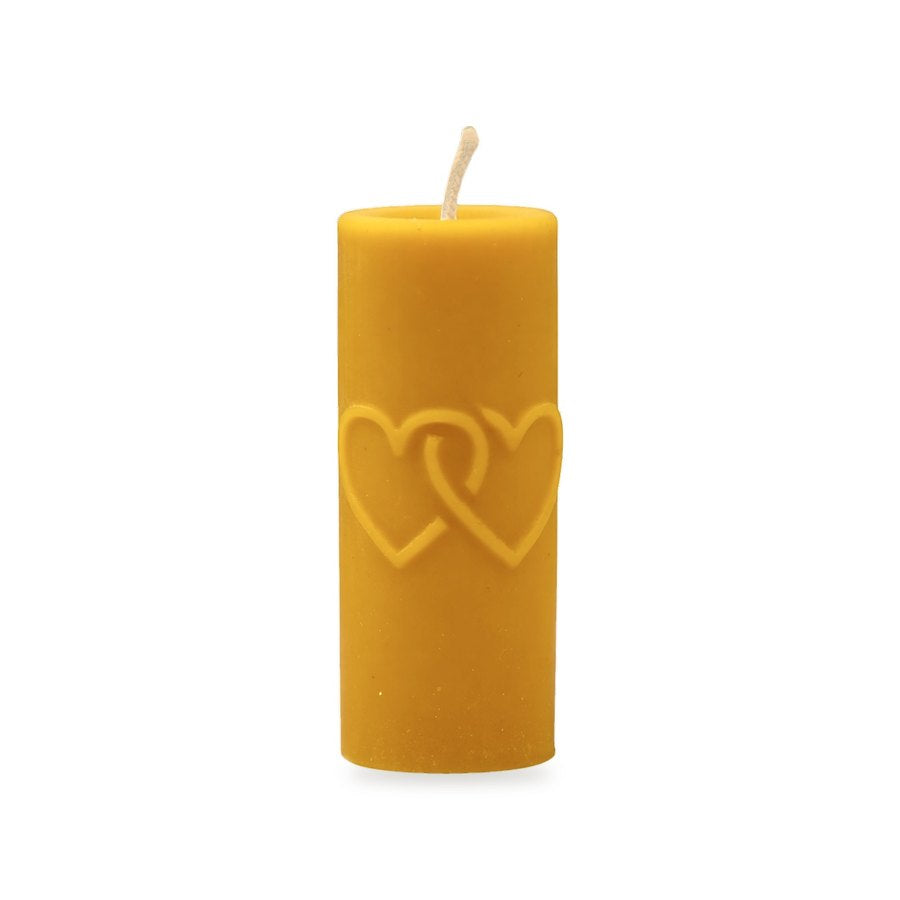 Hearts & Cross beeswax candle, white background studio photo