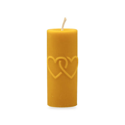 Hearts & Cross beeswax candle, white background studio photo