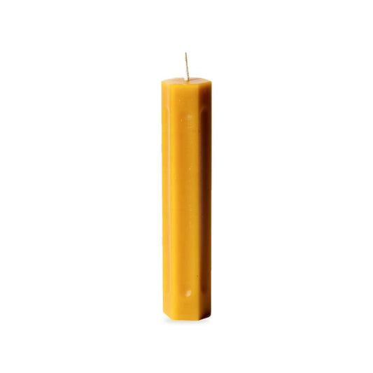 Small Ribbed Taper beeswax candle, white background studio photo