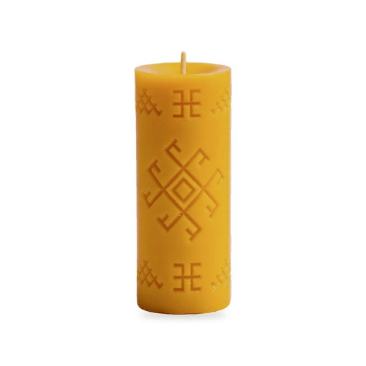 Thunder Cross beeswax pillar with central geometric symbol and border motifs on white