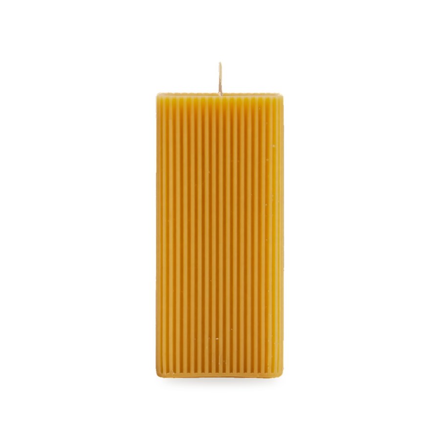 Triangle Fluted Pillar beeswax candle, white background studio photo