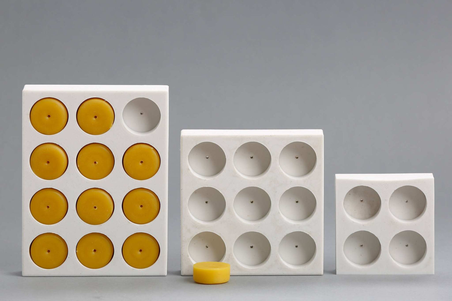 Silicone mold with multiple cavities for casting beeswax tea light candles