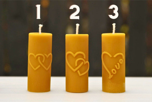 HEARTS & CROSS silicone candle molds showcasing three variations in yellow, including same-level hearts, a lower heart design, and a heart with "love" text.